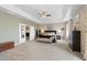 Carpeted main bedroom with tray ceilings, designer wallpaper, and plenty of open space at 17102 W 85Th Pl, Arvada, CO 80007