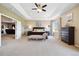 Spacious bedroom features carpet, a large bed, a chaise lounge, and lots of natural light at 17102 W 85Th Pl, Arvada, CO 80007