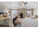 Spacious carpeted main bedroom with tray ceilings, large windows, and access to a private balcony at 17102 W 85Th Pl, Arvada, CO 80007