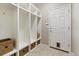 Bright mudroom features a built-in cubby system, tiled flooring, and a convenient door for easy access at 17102 W 85Th Pl, Arvada, CO 80007