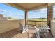 Covered patio with beautiful scenic views, wooden floors and comfortable seating at 17102 W 85Th Pl, Arvada, CO 80007
