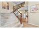 Beautiful staircase featuring wooden rails, carpeted steps, and natural light at 17102 W 85Th Pl, Arvada, CO 80007