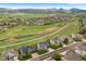 Overhead view of neighborhood with lush landscaping and tree lined streets, and views of mountains in distance at 6656 S Oak Cir, Littleton, CO 80127