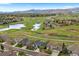 Stunning aerial view of a neighborhood with lush landscaping, water feature and mountain views at 6656 S Oak Cir, Littleton, CO 80127