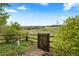 Picturesque backyard featuring wood fence, gate, lush greenery and views of open space at 6656 S Oak Cir, Littleton, CO 80127