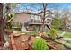 Lush backyard with brick patio featuring fire pit, seating area and beautiful landscaping at 6656 S Oak Cir, Littleton, CO 80127