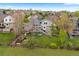 Spacious backyard with lush lawn, landscaped garden beds, and outdoor seating area with deck at 6656 S Oak Cir, Littleton, CO 80127