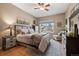 Cozy bedroom featuring a ceiling fan, a side chair, and neutral-toned walls at 6656 S Oak Cir, Littleton, CO 80127