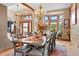 Bright dining room showcases a large table, bay window, and stylish chandeliers at 6656 S Oak Cir, Littleton, CO 80127