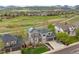 Beautifully landscaped home features mature trees, rock accents, and a well-manicured lawn at 6656 S Oak Cir, Littleton, CO 80127