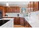Well-lit eat-in kitchen featuring stainless steel appliances, modern fixtures, and white quartz countertops at 6656 S Oak Cir, Littleton, CO 80127