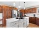 Bright eat-in kitchen boasts custom wood cabinets, stainless steel appliances, hardwood floors, and quartz countertops at 6656 S Oak Cir, Littleton, CO 80127