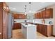 Bright eat-in kitchen featuring stainless steel appliances, custom wood cabinets, and a white center island at 6656 S Oak Cir, Littleton, CO 80127