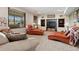Cozy living room with large windows, built-in shelves and entertainment center at 6656 S Oak Cir, Littleton, CO 80127