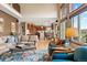 Inviting living room showcasing a bright sitting area, lake views, and a seamless transition to a modern kitchen at 6656 S Oak Cir, Littleton, CO 80127