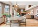 Open-concept living room and dining area featuring vaulted ceilings and large windows showcasing scenic views at 6656 S Oak Cir, Littleton, CO 80127