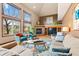 Cozy living room features a fireplace, large windows, and comfortable seating at 6656 S Oak Cir, Littleton, CO 80127