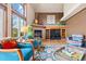 Inviting living room showcases a fireplace, built-in shelving, and large windows with natural light at 6656 S Oak Cir, Littleton, CO 80127