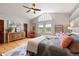 Spacious main bedroom boasts a ceiling fan, an arched window, and neutral-toned walls at 6656 S Oak Cir, Littleton, CO 80127