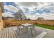 Relaxing backyard patio with a dining set, privacy fence, and lush green lawn at 8105 W 62Nd Ave, Arvada, CO 80004