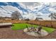 Spacious backyard with a fire pit, seating area, lawn and deck at 8105 W 62Nd Ave, Arvada, CO 80004