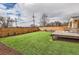 Beautiful backyard with manicured lawn, wooden fence, deck, and firepit area at 8105 W 62Nd Ave, Arvada, CO 80004