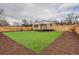 Inviting backyard featuring an expansive artificial lawn, wood fence, deck, and cozy fire pit area at 8105 W 62Nd Ave, Arvada, CO 80004