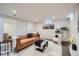 Inviting basement area with a comfortable seating arrangement, modern decor, and access to the laundry area for convenience at 8105 W 62Nd Ave, Arvada, CO 80004