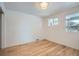 Bright bedroom with hardwood floors, two windows, and ample natural light at 8105 W 62Nd Ave, Arvada, CO 80004