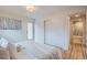 Bright bedroom with a modern closet and easy access to the bathroom, showcasing the home's convenient layout at 8105 W 62Nd Ave, Arvada, CO 80004