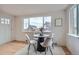 Bright dining area with hardwood floors, a window, and modern furniture at 8105 W 62Nd Ave, Arvada, CO 80004