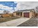 Charming home featuring a brick exterior, a driveway, and a well maintained lawn at 8105 W 62Nd Ave, Arvada, CO 80004