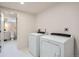 Convenient laundry room with washer, dryer, and access to bathroom at 8105 W 62Nd Ave, Arvada, CO 80004