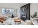 Cozy living room with a modern fireplace, dining area, and lots of natural light at 8105 W 62Nd Ave, Arvada, CO 80004