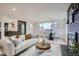 Cozy living room featuring hardwood floors, a fireplace, and plenty of natural light at 8105 W 62Nd Ave, Arvada, CO 80004