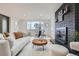 Bright living room featuring a black brick fireplace, a comfortable couch, and stylish decor for a cozy and inviting space at 8105 W 62Nd Ave, Arvada, CO 80004