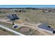 Picturesque property featuring a home, horse barn, and round pen, all enclosed by pristine white fencing at 1465 Arabian Trl, Elizabeth, CO 80107