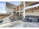Inviting backyard patio features a hot tub, staircase, and rock landscaping at 1465 Arabian Trl, Elizabeth, CO 80107