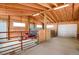 Spacious barn interior with stalls, gates, and tools at 1465 Arabian Trl, Elizabeth, CO 80107