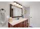 Charming bathroom with a wood vanity, a framed mirror, and updated fixtures at 1465 Arabian Trl, Elizabeth, CO 80107