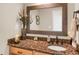 Bathroom features a granite countertop vanity with wood drawers and a framed mirror at 1465 Arabian Trl, Elizabeth, CO 80107