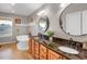 Bathroom features double vanity, large soaking tub, decorative mirrors, and natural light at 1465 Arabian Trl, Elizabeth, CO 80107
