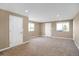 Large bonus room with neutral carpeting, lots of natural light, and doors to the outside at 1465 Arabian Trl, Elizabeth, CO 80107
