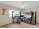 Comfortable bedroom featuring a bunk bed, a study desk next to a window and plush carpet floors at 1465 Arabian Trl, Elizabeth, CO 80107