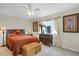 Bedroom features carpet, accent furniture, a ceiling fan, and a large window at 1465 Arabian Trl, Elizabeth, CO 80107