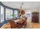 Formal dining room with hardwood floors, chandelier, lots of light, and dining table set at 1465 Arabian Trl, Elizabeth, CO 80107