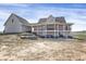 An exterior view of a charming two-story home with a wraparound porch at 1465 Arabian Trl, Elizabeth, CO 80107