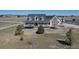 An aerial view of a ranch home featuring a large front yard with a white fence in the background at 1465 Arabian Trl, Elizabeth, CO 80107