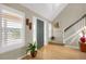 Bright foyer with hardwood floors, plantation shutters, a vaulted ceiling, and a staircase leading to the upper level at 1465 Arabian Trl, Elizabeth, CO 80107