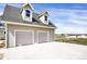 Spacious garage with two doors and ample parking space on a paved driveway at 1465 Arabian Trl, Elizabeth, CO 80107